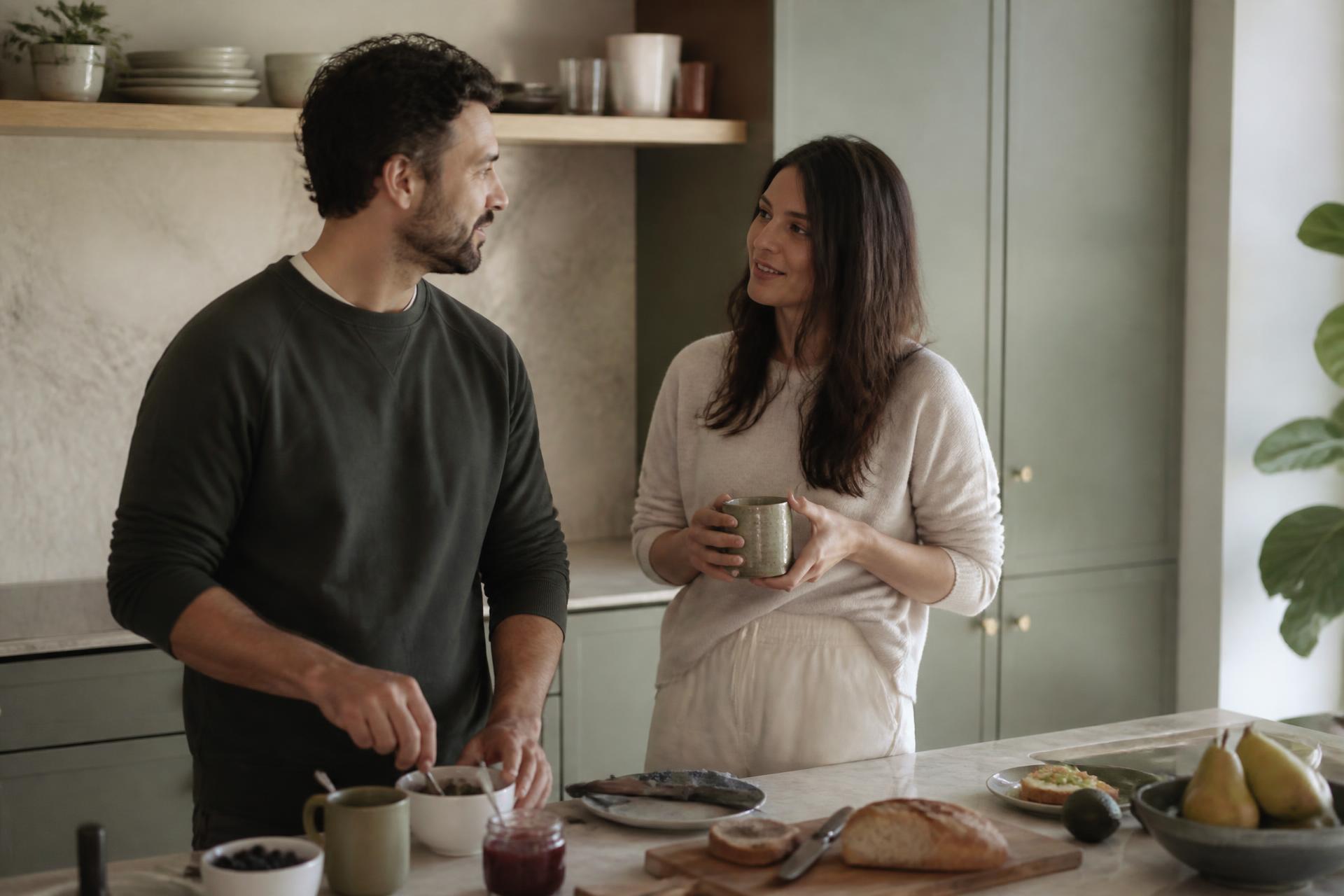A couple making breakfast together in their bright modern kitchen